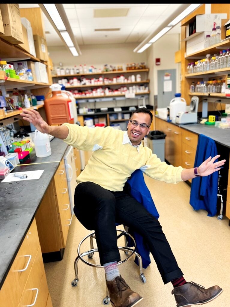 Gyan Prakash roling on a chair in the lab