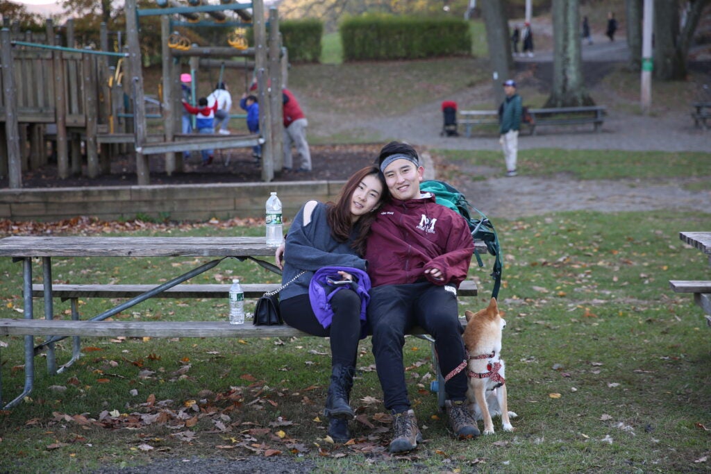 Zeqiu and his wife enjoying a walk in the park with their dog Ergou