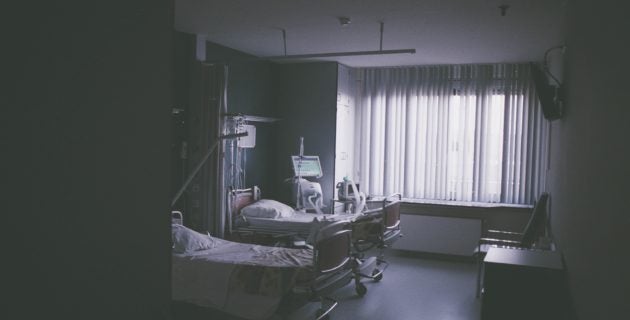 An empty hospital room with two beds.