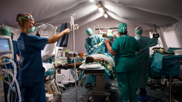 Italian Emergency Medical Team in surgery in a field hospital
