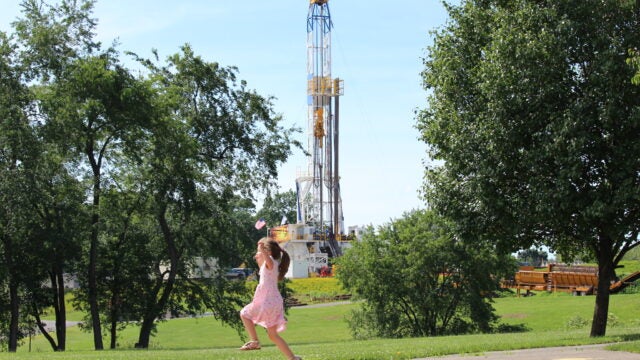 Girl plays near fracking site