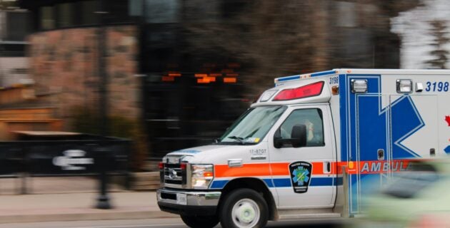 ambulance speeds down a city street