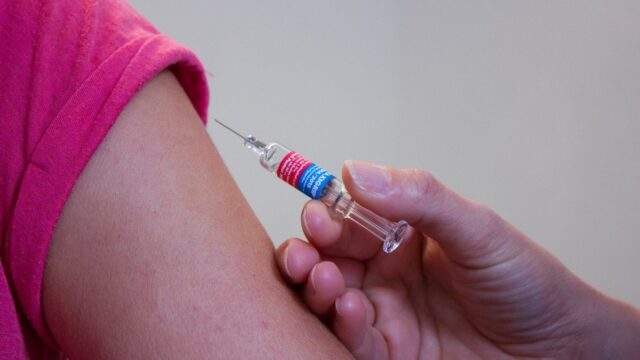 Someone receives a vaccination in their arm