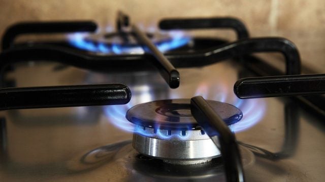 A lit burner on a gas stove