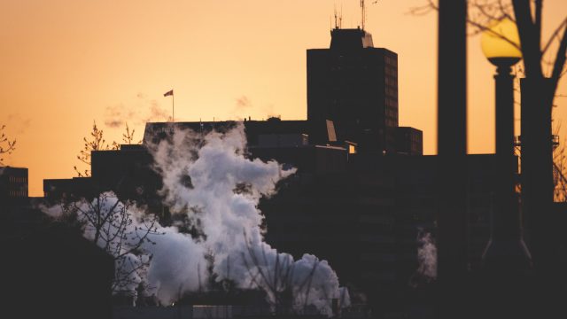 Pollution rises from a city building