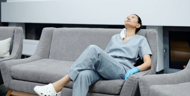 exhausted nurse rests on a couch