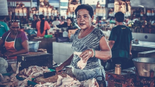 a woman sells meat in a market in Marga, Indonesia