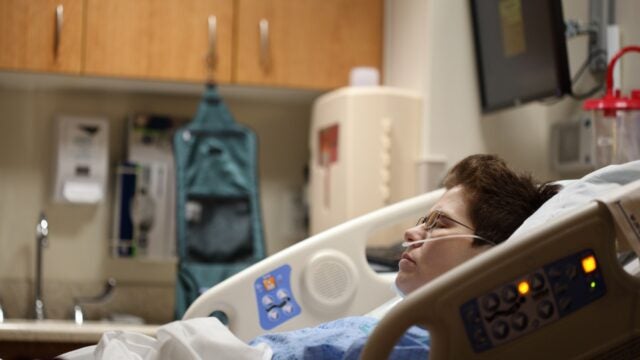 Woman lying in hospital bed