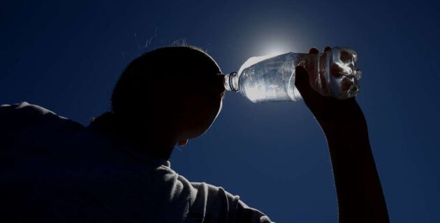 Person drinking water on a hot day