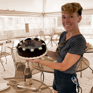 Kelsey holding a cake during her defense celebrations