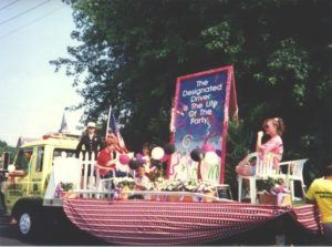 Children on parade float featuring U.S. Designated Driver Campaign ad: The Designated Driver Is the Life of the Party" (Harvard Alcohol Project)