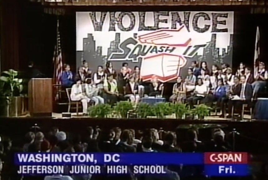 Shot of stage with "Squash It!" Campaign banner and students, Harvard-MetLife Leadership Forum (May 16, 1997, featuring First Lady Hillary Clinton)