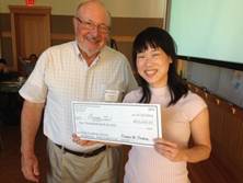 Doug Dockery presents Peggy Lai her check for winning the flash funding competition at the Harvard-NIEHS Center retreat