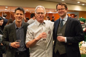 Three faculty members in a group photo at the Cutter Lecture reception