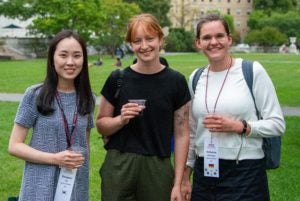 Three students in a group photo at the fall welcome BBQ