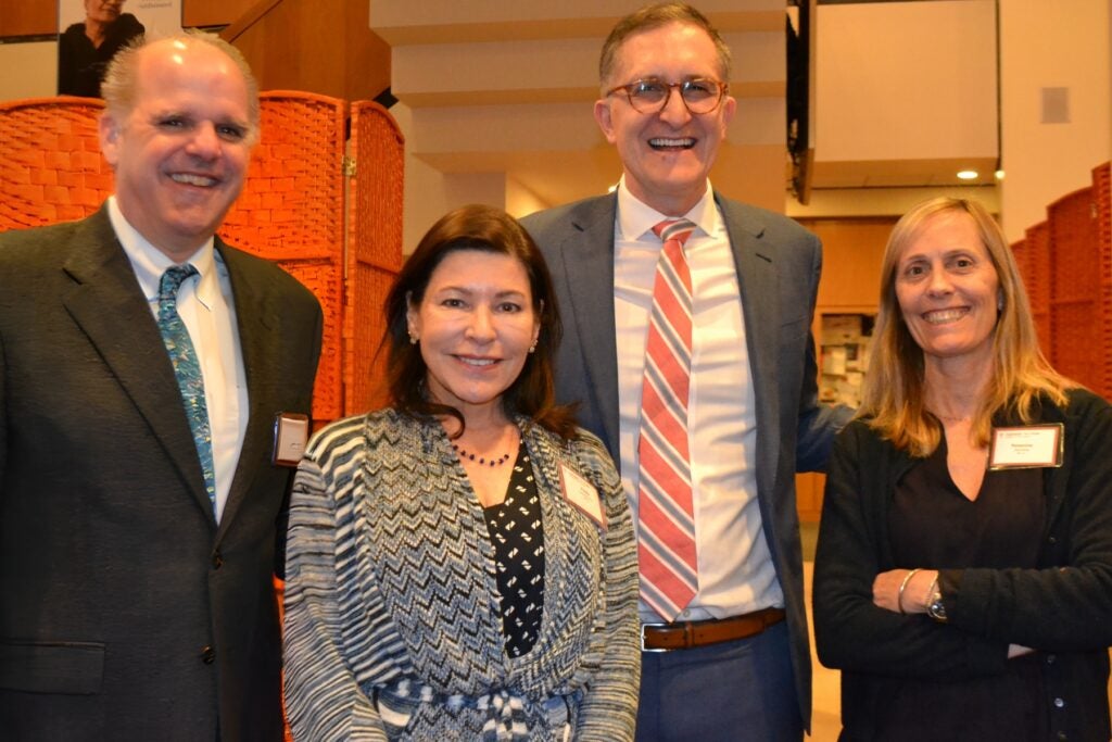 Dean Baccarelli poses with three fellowship celebration guests