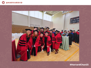 Ten Harvard Chan students in graduation regalia smiling for the camera.