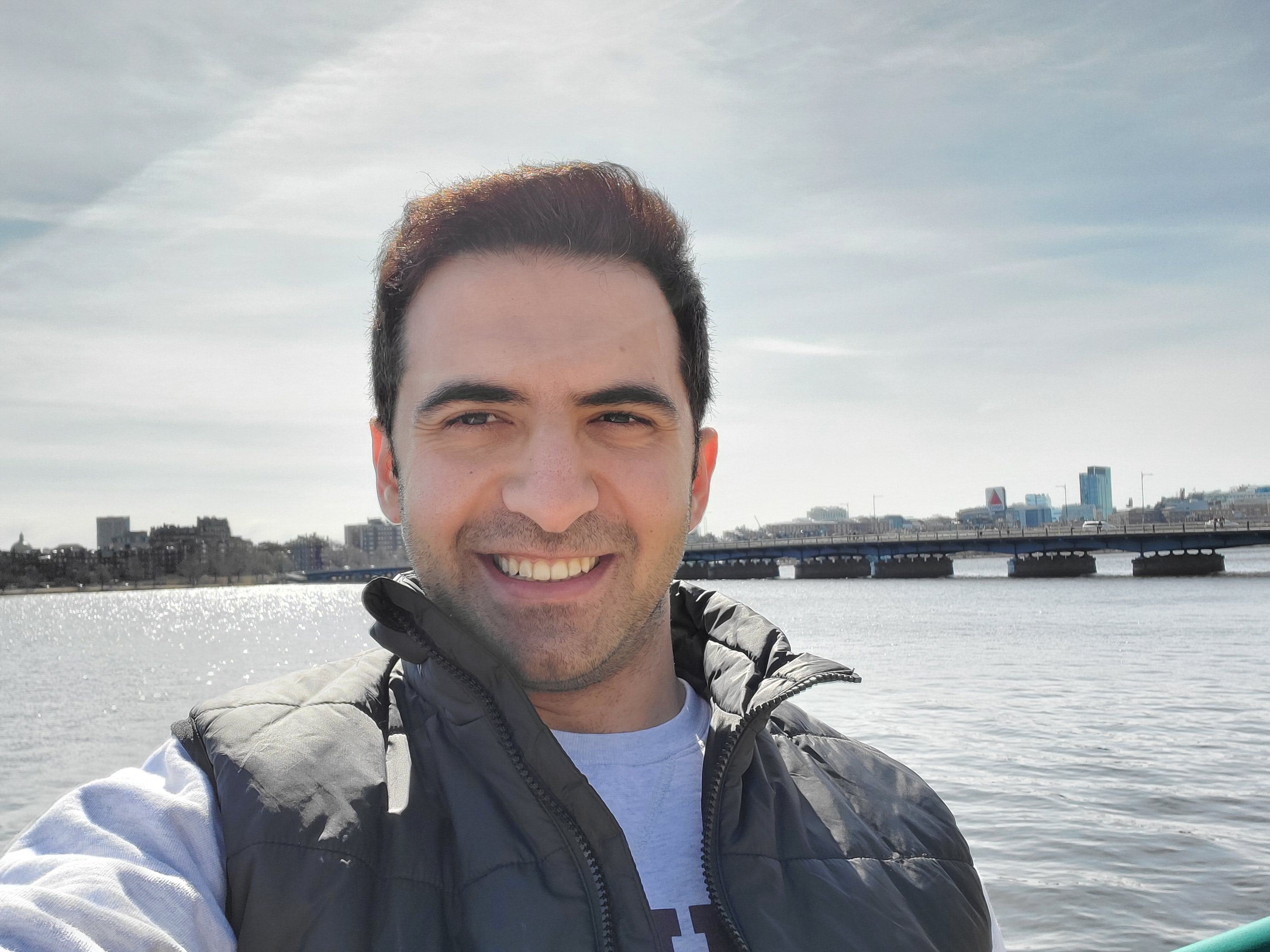 A picture of Khaled in front of the Charles river in Boston.