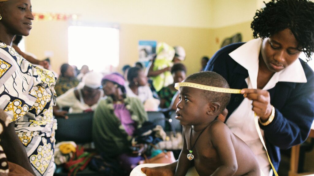 Doctor visiting a child in Nigeria - photo by Dominic Chavez