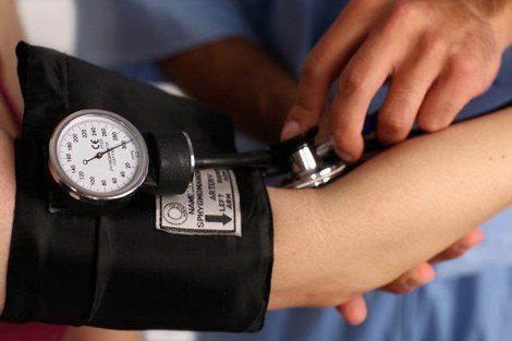 Medical worker checking blood pressure