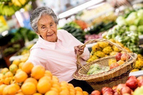 Latino woman picking fruit