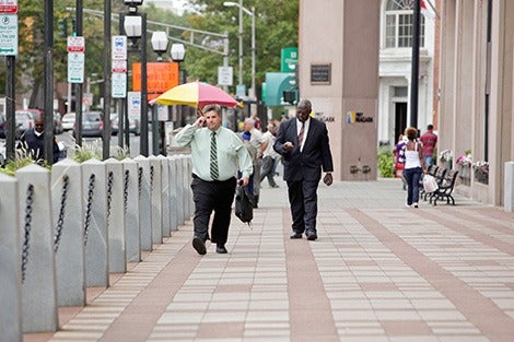 Men walking down sidewalk