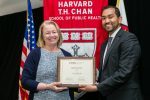Vidur Sharma, Harvard Chan Student Association president giving award