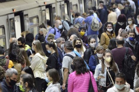 Subway train passengers with protective masks crowding to get on and off subway station platform on Serdika Metro station, Sophia, Bulgaria.