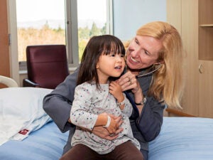 Nadeau with a young patient at the Sean N. Parker Center for Allergy & Asthma Research at Stanford University 