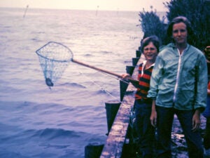 Childhood photo of Kari Nadeau and her brother catching crabs