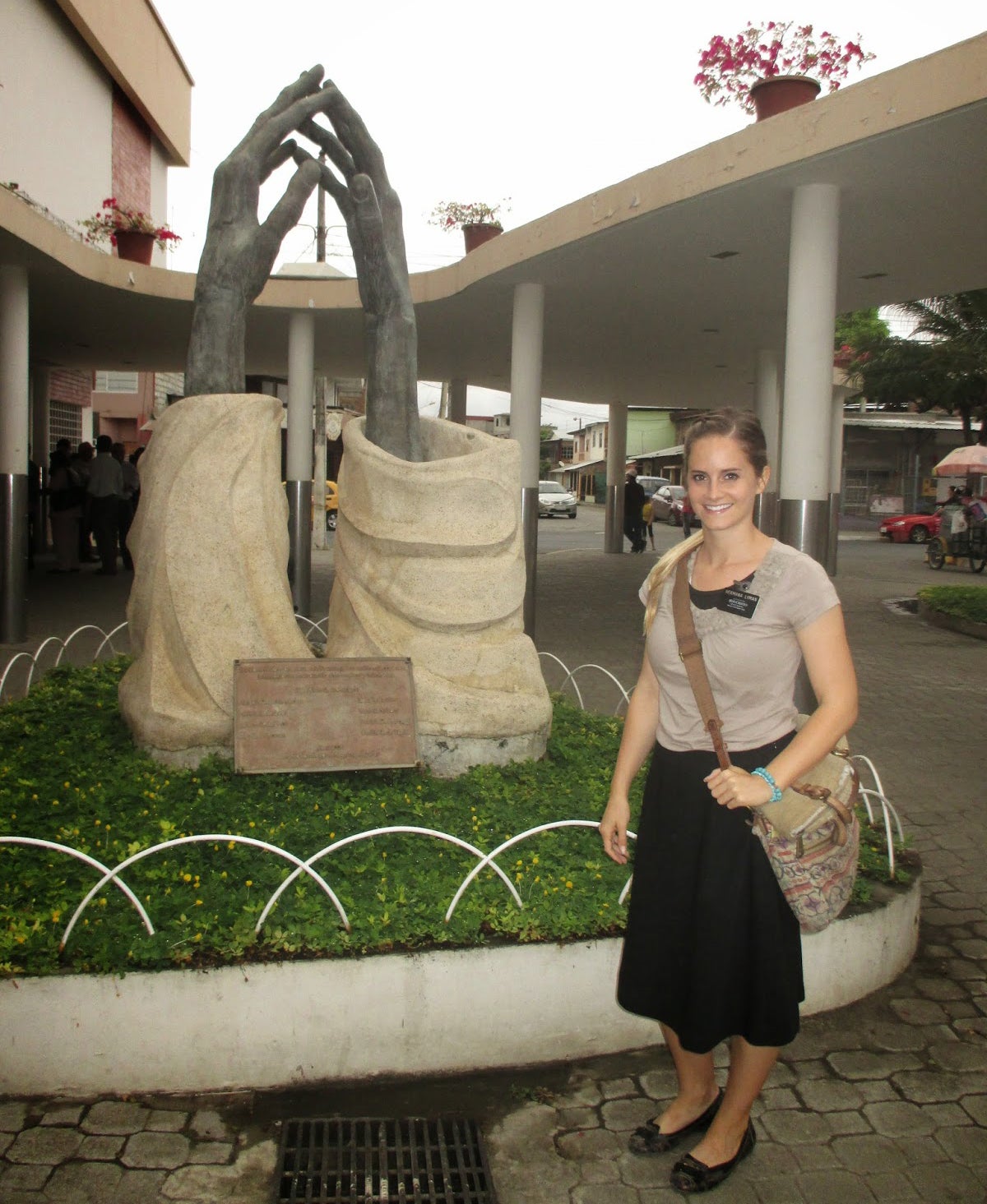 Trissa Lyman poses near sculpture in Ecuador