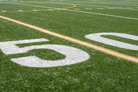View of the fifty-yard line on the sideline of a football field