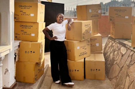 Valencia Lambert prepares to unpack boxes of OraQuick HIV self-tests in Mbarara, Uganda.