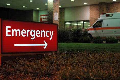 Emergency room entrance at night with ambulance