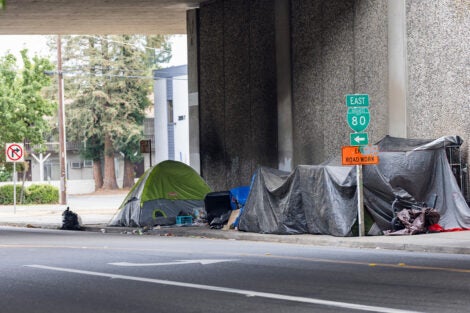 homeless tents under a bridge