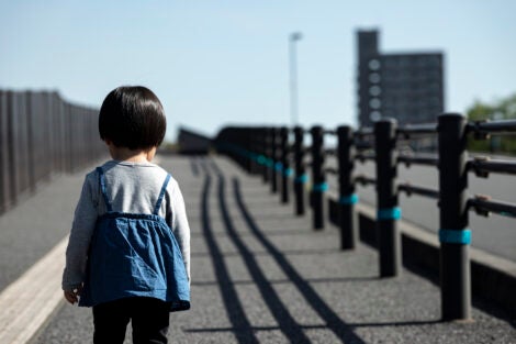 Two year old child walking alone.