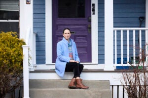 Bethany Kotlar sitting on the stoop of her house