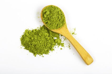 Top view green matcha tea powder isolated on white background