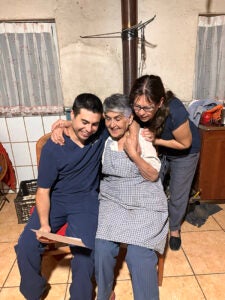 Alberto Inzulza Galdames, his grandmother, and mother read his acceptance letter from Harvard Chan School