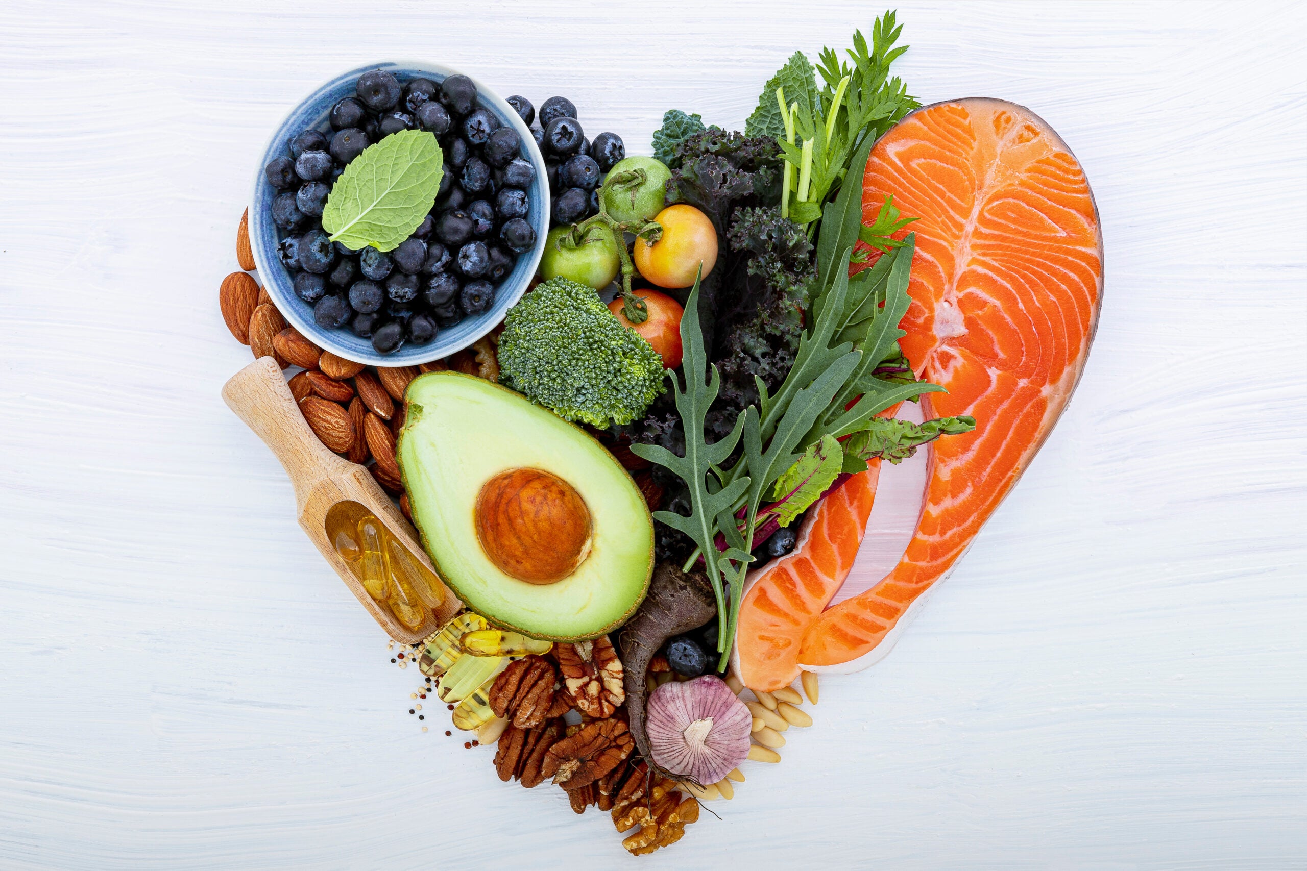 a variety of heart healthy foods arranged in the shape of a heart