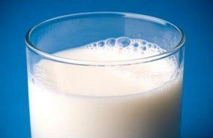 glass of milk against dark blue background