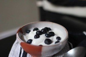 Cup of yogurt topped with blueberries