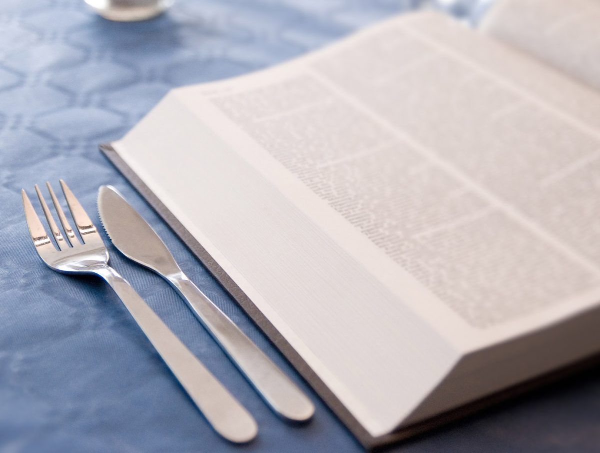 Diet book with fork and knife on table