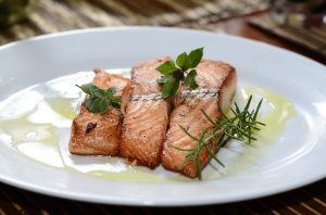 salmon with dill on a plate drizzled with olive oil