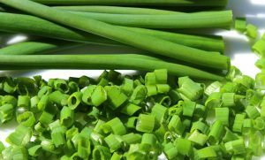 chives on a plate, some chopped