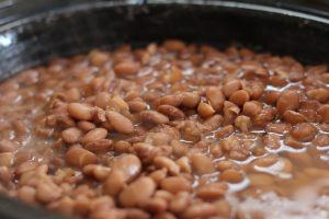 pinto beans soaking in a pot of water