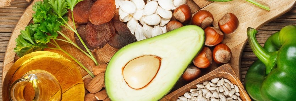 Foods rich in vitamin E such as wheat germ oil, dried wheat germ, dried apricots, hazelnuts, almonds, parsley leaves, avocado, walnuts, pumpkin seeds, sunflower seeds, spinach and bell pepper