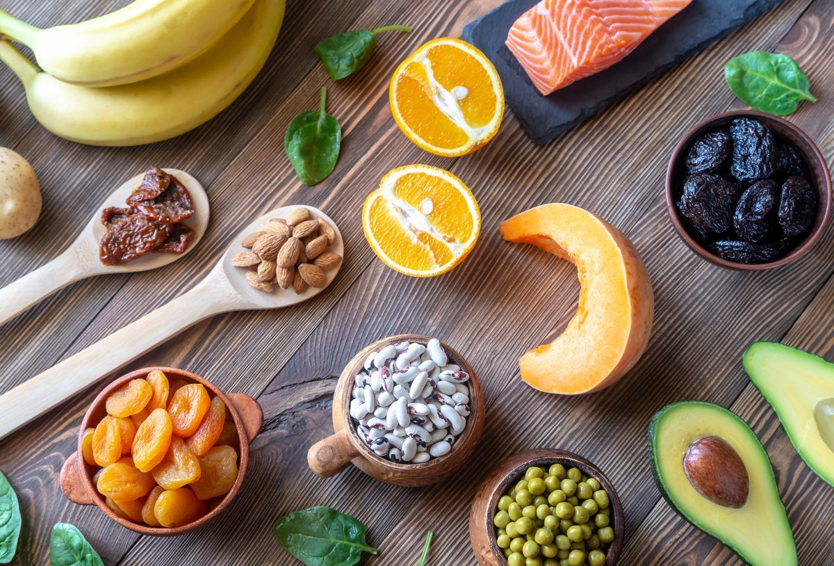 Potassium foods including bananas, almonds, dried fruit, beans, avocado, cantaloupe, salmon, spinach