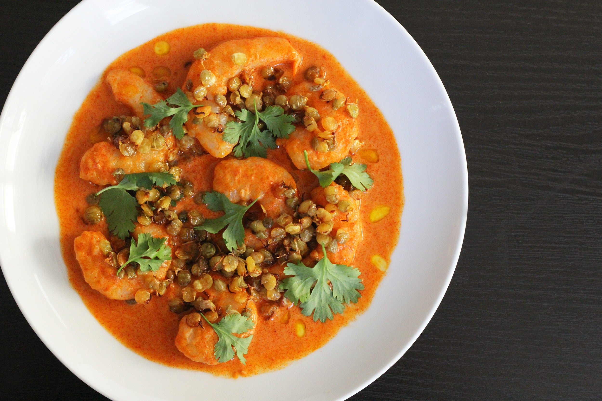 Shrimp with red curry and crispy sprouted lentils