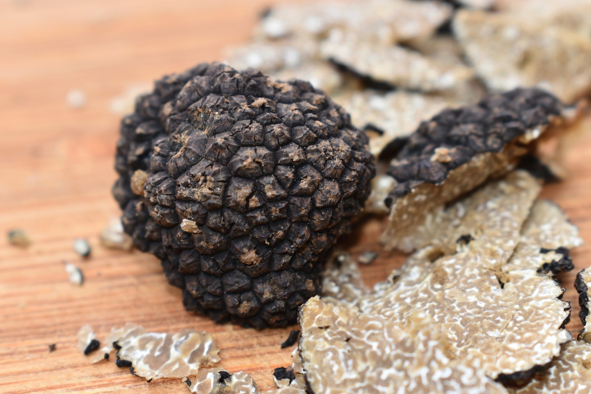 Black truffle on a cutting board with shavings